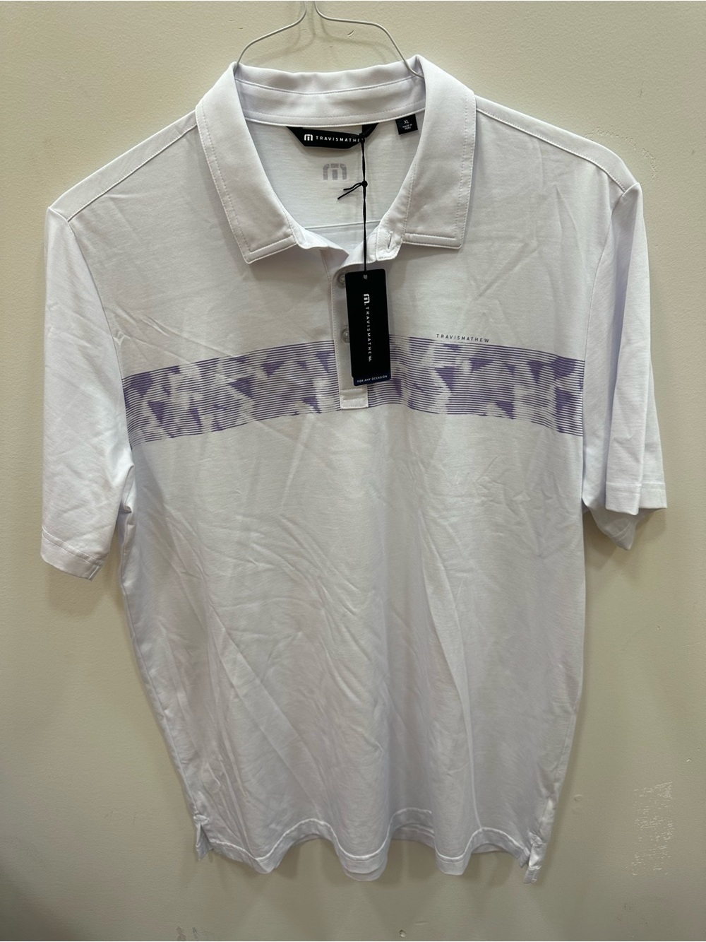 Travis Mathew White Polo with Lavender Graphic Chest Stripe